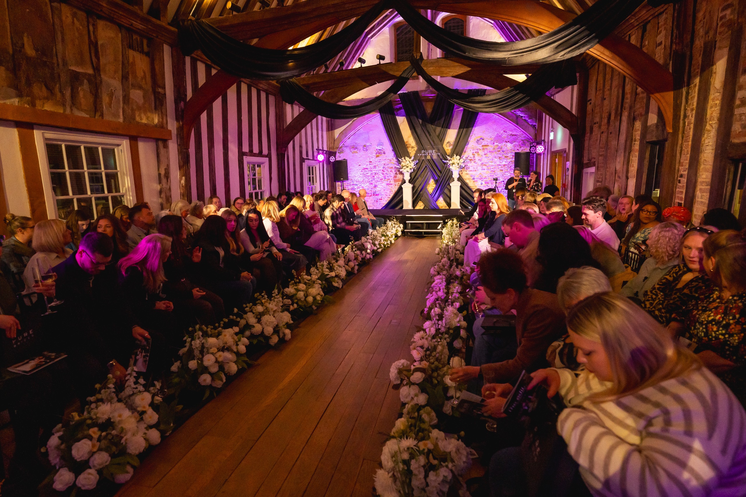 The Pure Brides fashion show catwalk surrounded by guests