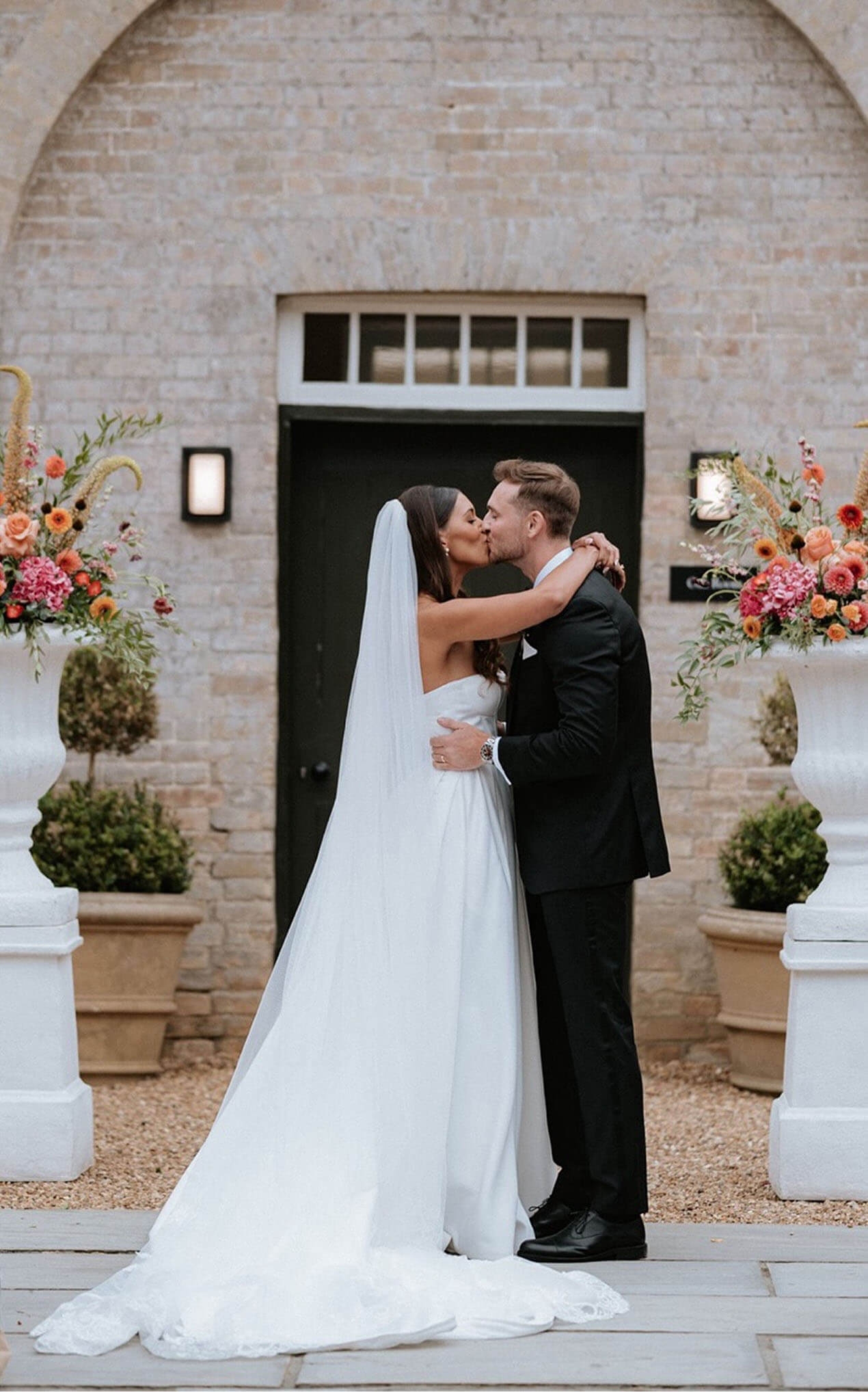 Сouple wearing a white gown and a black suit