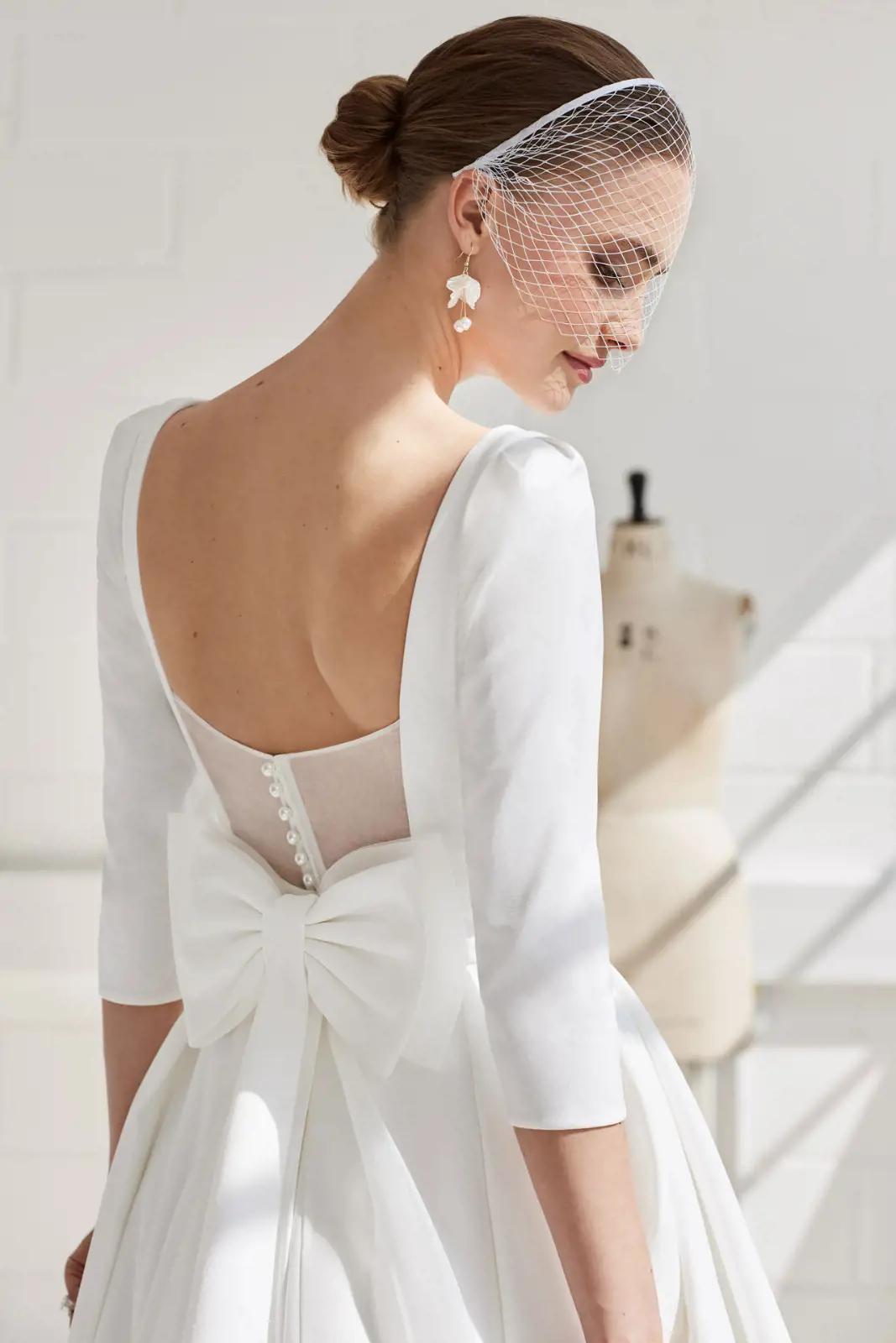 Model wearing a white Classic Gown